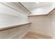 Bright walk-in closet features custom shelving and wood-look flooring at 368 Legacy Dr, Henderson, NV 89014