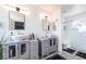Bathroom with dual sinks, and a shower with glass door at 3695 Funston Way, Las Vegas, NV 89129