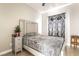 Comfortable bedroom with a gray bed, a Christmas tree, and stylish nightstand at 3695 Funston Way, Las Vegas, NV 89129