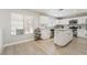 Spacious kitchen with white cabinetry, stainless steel appliances and modern finishes at 3695 Funston Way, Las Vegas, NV 89129