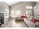 Bright living room with a vaulted ceiling, light wood flooring, and ample natural light at 3695 Funston Way, Las Vegas, NV 89129