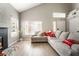 Bright living room with a vaulted ceiling, light wood flooring, and ample natural light at 3695 Funston Way, Las Vegas, NV 89129