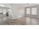 Open concept living room with wood flooring, a rocking chair, and natural lighting at 3695 Funston Way, Las Vegas, NV 89129