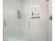 Modern shower featuring sleek white tile and recessed shelves at 3695 Funston Way, Las Vegas, NV 89129