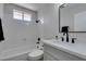 Bathroom featuring white tile, modern black fixtures, and a sleek vanity at 3800 Summer Breeze Cir, Las Vegas, NV 89108