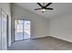 Spacious bedroom featuring gray carpet, neutral walls, ceiling fan and sliding glass door at 3800 Summer Breeze Cir, Las Vegas, NV 89108