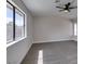 Spacious bedroom featuring a ceiling fan, neutral carpet, and plenty of natural light from a large window at 3800 Summer Breeze Cir, Las Vegas, NV 89108