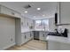 Updated kitchen with white cabinets, stainless steel appliances, and quartz countertops at 3800 Summer Breeze Cir, Las Vegas, NV 89108