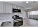 Updated kitchen featuring stainless steel appliances, white countertops, and modern gray cabinets at 3800 Summer Breeze Cir, Las Vegas, NV 89108