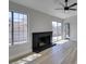 Spacious living room with wood-look floors, fireplace, and sliding doors to backyard at 3800 Summer Breeze Cir, Las Vegas, NV 89108