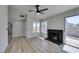 Spacious living room with wood-look flooring, fireplace, and outdoor access at 3800 Summer Breeze Cir, Las Vegas, NV 89108