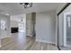 Spacious living room with wood-look floors, fireplace, and modern lighting, open to front door at 3800 Summer Breeze Cir, Las Vegas, NV 89108