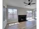 Light-filled living room showcasing wood-look floors, brick fireplace, and backyard view at 3800 Summer Breeze Cir, Las Vegas, NV 89108