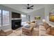Bright living room with a cozy fireplace and sliding glass door to the backyard at 3800 Summer Breeze Cir, Las Vegas, NV 89108