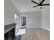 Open living room with wood-look flooring, brick fireplace, and sliding doors at 3800 Summer Breeze Cir, Las Vegas, NV 89108