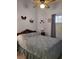 Bedroom features a bed with a blue cover, a ceiling fan and neutral colored walls at 3987 Saddlewood Ct, Las Vegas, NV 89121