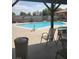 Community pool area featuring a sparkling pool, spa and outdoor seating at 3987 Saddlewood Ct, Las Vegas, NV 89121