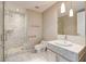 Neutral bathroom featuring a glass enclosed shower with a built-in shelf and a white vanity at 4471 Dean Martin Dr # 4001, Las Vegas, NV 89103