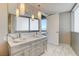 Bathroom features a double sink vanity with marble countertop, modern lighting and access to the exterior at 4471 Dean Martin Dr # 4001, Las Vegas, NV 89103