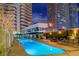 Stunning nighttime view of the resort style pool with modern buildings in the background at 4471 Dean Martin Dr # 4001, Las Vegas, NV 89103