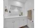 Bright bathroom with a large mirror, double vanity and modern finishes at 471 Secret Cove Ct, Henderson, NV 89002