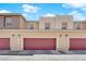 Home exterior featuring three garage doors at 471 Secret Cove Ct, Henderson, NV 89002