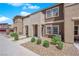 Charming townhome showcasing a well-kept exterior with gravel landscaping and healthy bushes at 471 Secret Cove Ct, Henderson, NV 89002