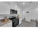 Modern kitchen features stainless steel appliances and sleek white cabinetry at 471 Secret Cove Ct, Henderson, NV 89002
