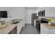 Sleek, modern kitchen features stainless steel appliances, quartz countertops, and laminate flooring at 471 Secret Cove Ct, Henderson, NV 89002