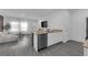 Open concept living room and kitchen feature modern finishes and wood-style flooring at 471 Secret Cove Ct, Henderson, NV 89002