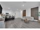 Bright, open-concept living space with stylish gray laminate flooring and modern accents at 471 Secret Cove Ct, Henderson, NV 89002