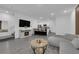 Open-concept living area features gray laminate flooring and seamless flow to the kitchen at 471 Secret Cove Ct, Henderson, NV 89002