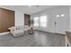 Inviting living room features cozy seating, wood accent wall, and modern gray laminate flooring at 471 Secret Cove Ct, Henderson, NV 89002