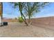 Backyard featuring mature trees, gravel, and a brick fence at 4910 Cielo Ct, Pahrump, NV 89061