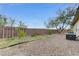 Backyard featuring mature trees, gravel, and a brick fence at 4910 Cielo Ct, Pahrump, NV 89061