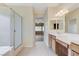Bathroom featuring double sinks, shower, and large mirror at 4910 Cielo Ct, Pahrump, NV 89061