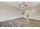 Comfortable bedroom with ceiling fan, wood-look floors, and an ensuite bathroom at 4910 Cielo Ct, Pahrump, NV 89061