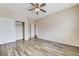 Bedroom features wood-look flooring, closet, and fan at 4910 Cielo Ct, Pahrump, NV 89061