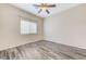 Bright bedroom featuring wood-look flooring and a ceiling fan with a light at 4910 Cielo Ct, Pahrump, NV 89061
