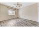 Bedroom featuring wood-look floors, a ceiling fan, and ample natural light at 4910 Cielo Ct, Pahrump, NV 89061