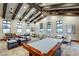 Spacious clubhouse interior featuring a pool table, comfortable seating, and ample natural light at 4910 Cielo Ct, Pahrump, NV 89061