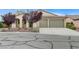 Charming single-story home featuring a well-manicured front yard and a spacious two-car garage at 4910 Cielo Ct, Pahrump, NV 89061