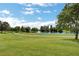 Picturesque golf course with lush green fairways, mature trees and a tranquil pond at 4910 Cielo Ct, Pahrump, NV 89061