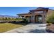 Exterior view of the Grill Room Bar entrance featuring a stone archway and adjacent lawn overlooking the mountains at 4910 Cielo Ct, Pahrump, NV 89061