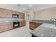 Well-lit kitchen featuring granite countertops, tile backsplash, and wooden cabinetry at 4910 Cielo Ct, Pahrump, NV 89061