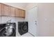 Well-equipped laundry room with modern washer and dryer, storage cabinets and easy access to the rest of the home at 4910 Cielo Ct, Pahrump, NV 89061