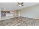 Living room displaying the hardwood floors, ceiling fan, and the kitchen's granite countertops at 4910 Cielo Ct, Pahrump, NV 89061