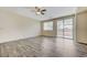 Large living room featuring hardwood floors, a ceiling fan, and sliding glass door access to the backyard at 4910 Cielo Ct, Pahrump, NV 89061