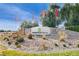 Stone sign at Mountain Falls entrance with lush desert landscape and clear skies at 4910 Cielo Ct, Pahrump, NV 89061