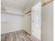 Large walk-in closet with shelving and wood-look floors at 4910 Cielo Ct, Pahrump, NV 89061